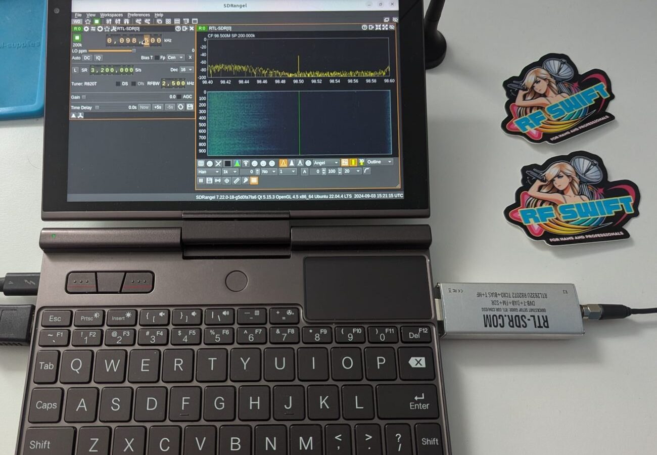 GPD Pocket laptop running SDRangel on a broadcast FM station, with an RTL-SDR dongle and RF Swift stickers