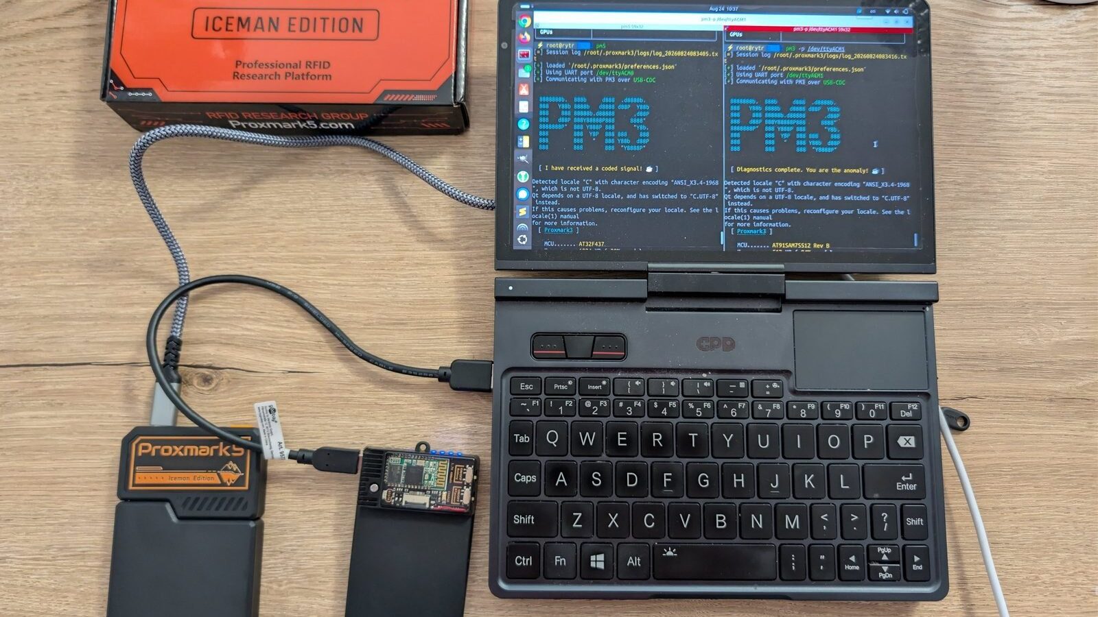 Proxmark5 and Proxmark3 connected to a pocket laptop running two Proxmark client sessions